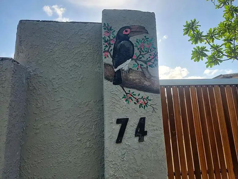 The hornbill painted on the gatepost at number 74